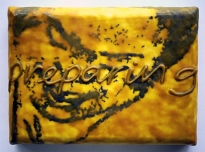 Preparing, 1998, graphite powder, poly vinyl acetate, photocopy transfer, African bees wax on canvas on board, 17 x 25 x 5 cms